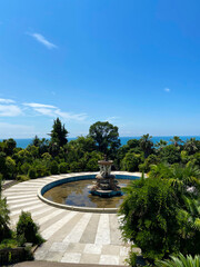 The old building and the fountain in the tropical garden