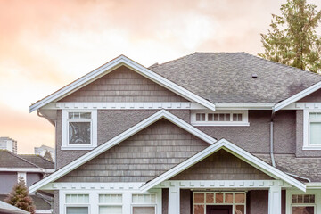 The top of the house or apartment building with nice window.