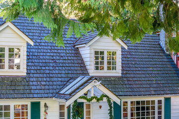 The top of the house or apartment building with nice window.