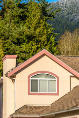 The top of the house or apartment building with nice window.