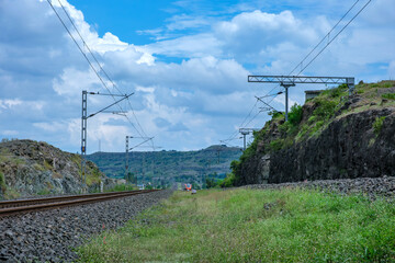 Saffron coloured Vande Bharat Express near Pune India. This is a tri-weekly train between Pune and Kolhapur and also a tri-weekly train between Pune and Hubballi.