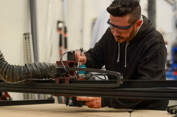 maintenance technician repairing a cutting machine