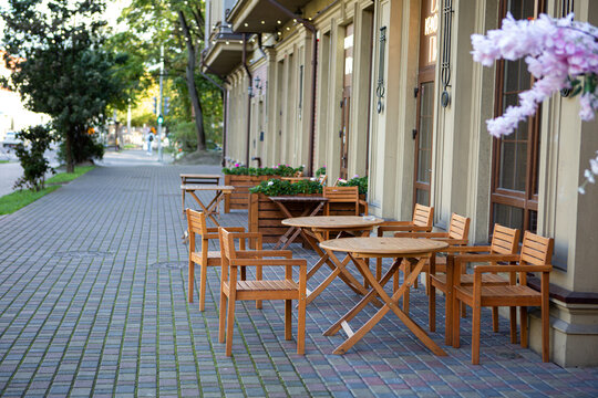 Amalienau district in Kaliningrad. Street, cafe, flowers and trees in a summer sunny day