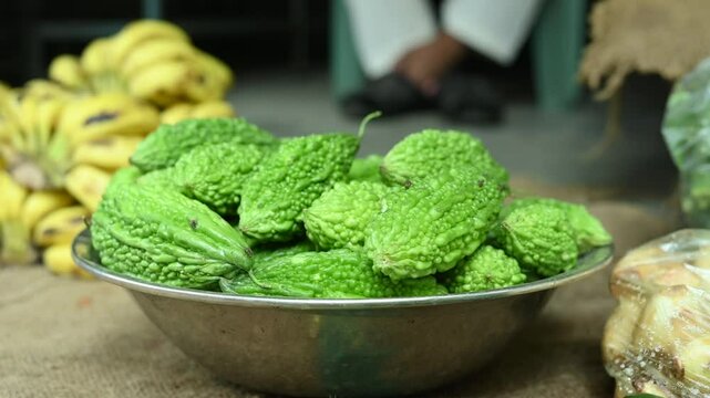 pile of fresh green bitter gourds or bitter melons