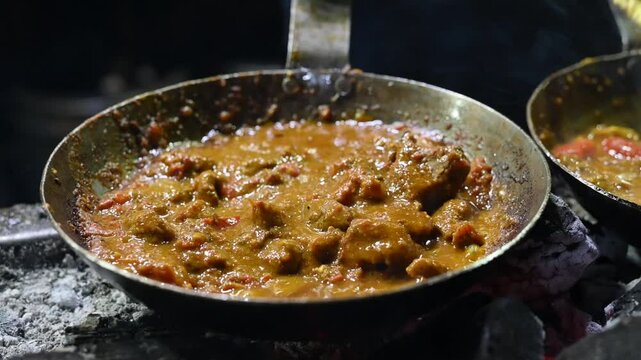 Pakistani cuisine traditional Lamb Karahi with spices and gravy close-up in a pan