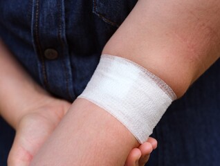 Close-up shot of a bandage on the woman arm after having blood taken