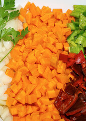 sliced ​​carrot, green and red pepper with parsley. Vertical macro photo