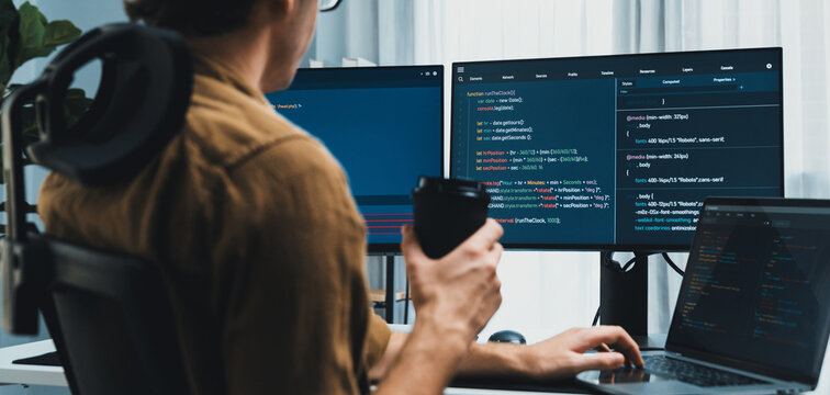 Working IT developer drinking coffee while working in creating program codding database job project on pc screen, thinking program for latest version application on website at modern office. Gusher.