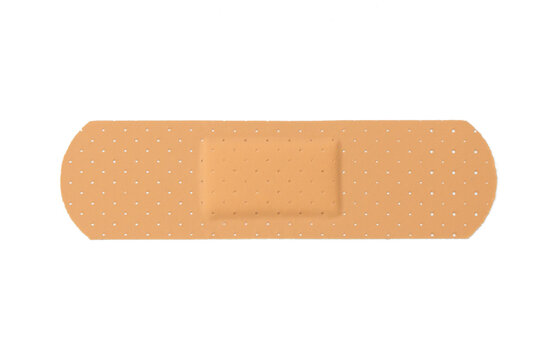 A simple adhesive bandage laid flat on a clean white surface. medical plaster isolated