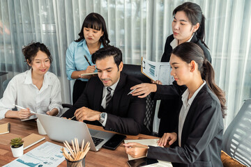 Diverse of business people from various ethnic group working in modern office environment. Productive and multi ethnic office workers engage in discussion for strategic business marketing. Meticulous