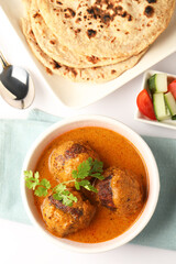 An extremely popular and tasty north indian creamy curry recipe made with aloo and paneer balls dunked in a creamy, silky smooth and rich sauce/ curry with roti or indian flat bread