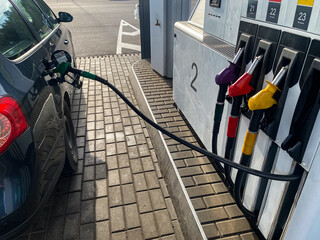 the process of filling a car with diesel fuel at a gas station