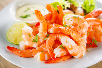 close up on shrimp with lemon and dipping sauce