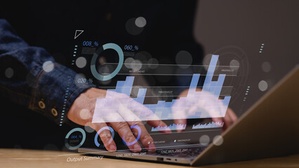 depicts persons hands typing on laptop, surrounded by dynamic data visualizations, integration of technology and analytics for informed decision-making