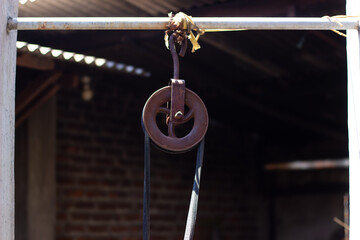 Old Rusty Pulley Hanging on a Metal Structure