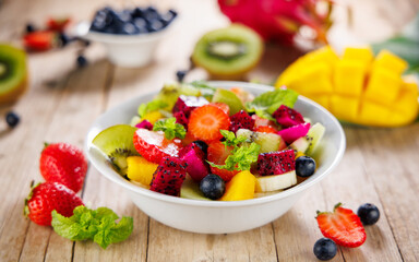 delicious exotic fruit salad with dragon fruit, mango, banana and blueberry