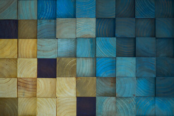 blue plaid background. A colourful wall backround made out of wooden cubes arranged like a puzzle. Perfect for wallpaper