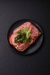 Focaccia with salami, cheese, tomatoes, arugula, salt, spices and herbs