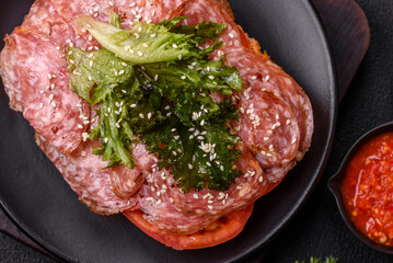 Focaccia with salami, cheese, tomatoes, arugula, salt, spices and herbs