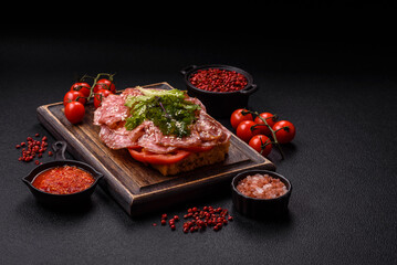 Focaccia with salami, cheese, tomatoes, arugula, salt, spices and herbs