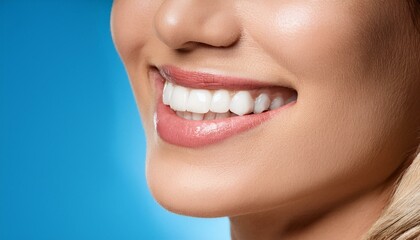Fototapeta premium Beautiful smile of young woman with healthy white teeth and blue backgorund