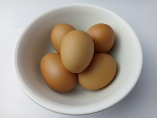 Group of brown raw eggs, isolated on white background