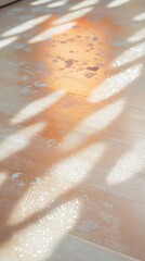 Fototapeta premium Soft sunlight filters through leaves, casting intricate shadows on the polished wooden surface