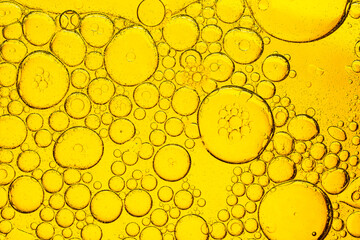 Yellow Macro Drink Bubbles,golden drops of oil or serum surface background,Yellow fat, like obesity...