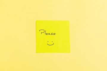 A yellow sticky note with a smiley face on it