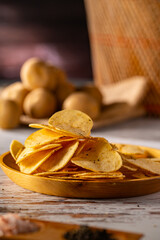 Potato chips on a wooden table.
