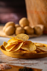 Potato chips on a wooden table.
