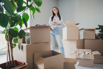 Full body photo of young girl crossed hands confident look empty space wear striped clothes buy new house enjoy cozy interior flat indoors