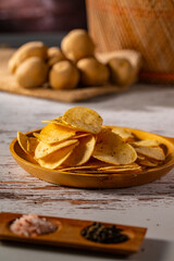 Potato chips on a wooden table.
