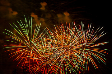 Multicolored Red Green Gold Bright Fireworks Sparks on Black Sky