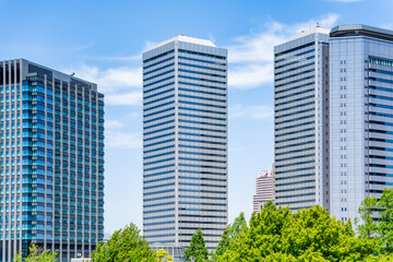 Modern glass skyscrapers seen from the upper floors of Osaka Castle, Japan.