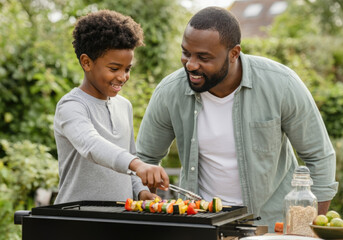 Happy father and son grilling vegetable skewers on a barbecue in the backyard