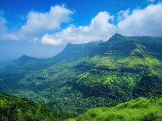 Fototapeta premium breathtaking view of a mountain range under brilliant blue skies, celebrating the majesty of nature with lush greenery and dramatic peaks, invoking a sense of wonder and tranquility
