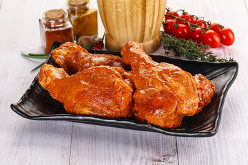 Raw turkey shoulder wing in Indian tandoori marinade