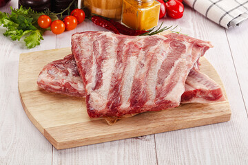 Raw pork ribs over board