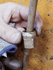 human fingers of factory worker with nut tool