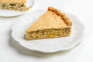 Chicken and egg pie on a light plate