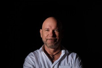 Fototapeta premium Smiling bald man in white shirt portrait