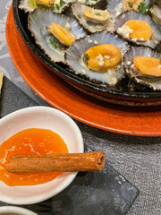 Grilled limpets, a traditional Azorean dish, served with fresh lemon and herbs. A delightful taste of the sea, showcasing the region's rich culinary heritage.