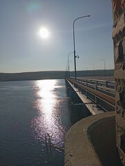 Bridge over the river. Sun glare on the water