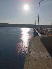 Bridge over the river. Sun glare on the water