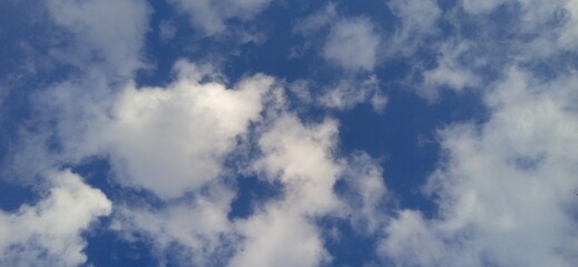 Bright sky with fluffy white clouds