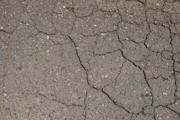 Abstract shapes, patterns and textures of cracked asphalt roads.Damaged asphalt road surface. for graphic design or banner background