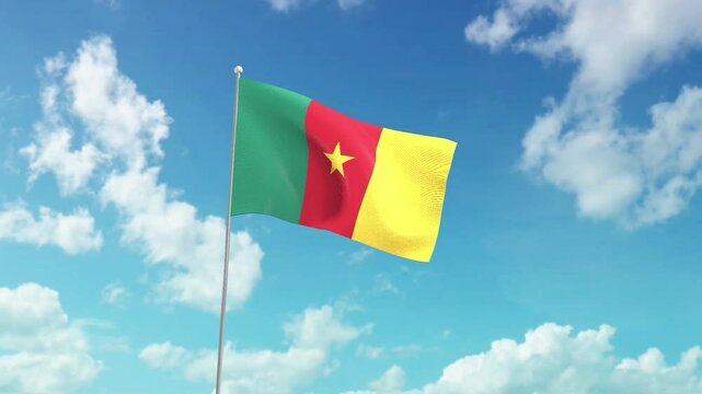 The national flag of Cameroon, flies against the blue sky.