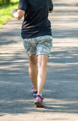 A woman is running on a road with a pair of camo shorts