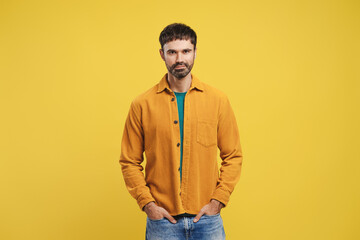 Confident, happy, bearded Hispanic man wearing stylish casual clothes, hands in pocket